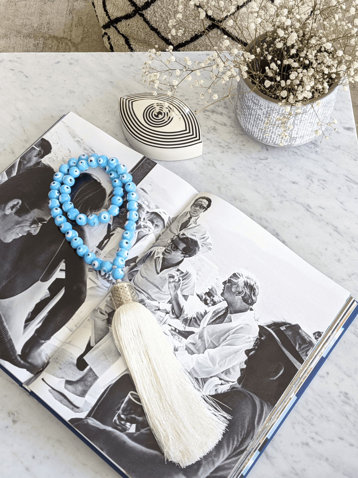 Evil eye bead strand • Turquoise evil eye • Glass bead evil eye • Handmade evil eye • Misbaha beads • Modern prayer beads • Table decor evil eye • Boho home decor • Evil eye protection • Middle Eastern home decor • Housewarming gift • Meaningful gift • Stylish Luck • Made in Israel
שרשרת עין הרע • חרוזי עין • קישוט שולחן • אובייקט עיצובי • חרוזי זכוכית בעבודת יד • מסבחה מודרנית • שמירה מעין הרע • עיצוב הבית • חפצי נוי • מתנה לחנוכת בית • מתנה משמעותית • סמלי מזל • Stylish Luck • מיוצר בישראל