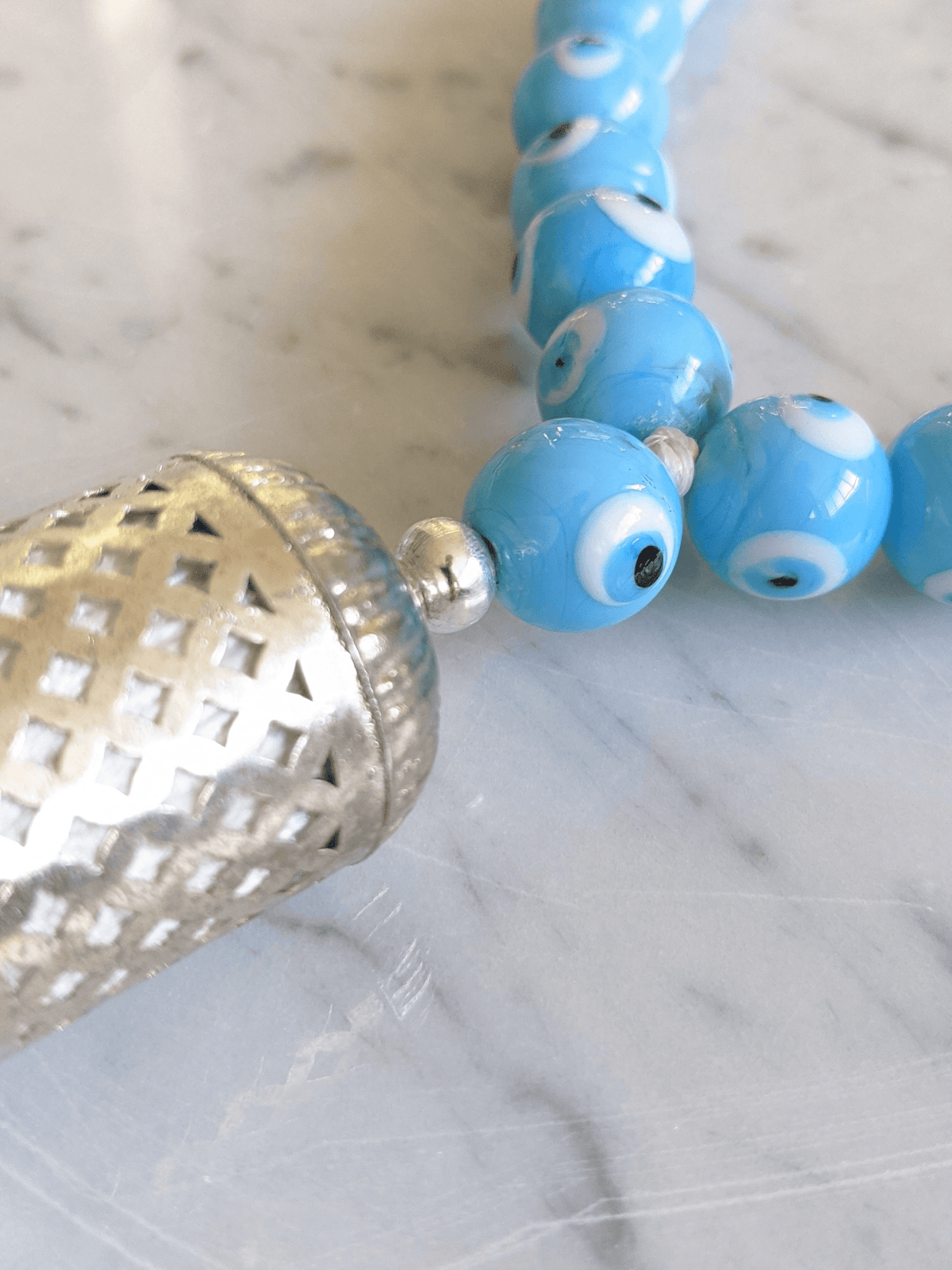 
Evil eye bead strand • Turquoise evil eye • Glass bead evil eye • Handmade evil eye • Misbaha beads • Modern prayer beads • Table decor evil eye • Boho home decor • Evil eye protection • Middle Eastern home decor • Housewarming gift • Meaningful gift • Stylish Luck • Made in Israel 
שרשרת עין הרע • חרוזי עין • קישוט שולחן • אובייקט עיצובי • חרוזי זכוכית בעבודת יד • מסבחה מודרנית • שמירה מעין הרע • עיצוב הבית • חפצי נוי • מתנה לחנוכת בית • מתנה משמעותית • סמלי מזל • Stylish Luck • מיוצר בישראל