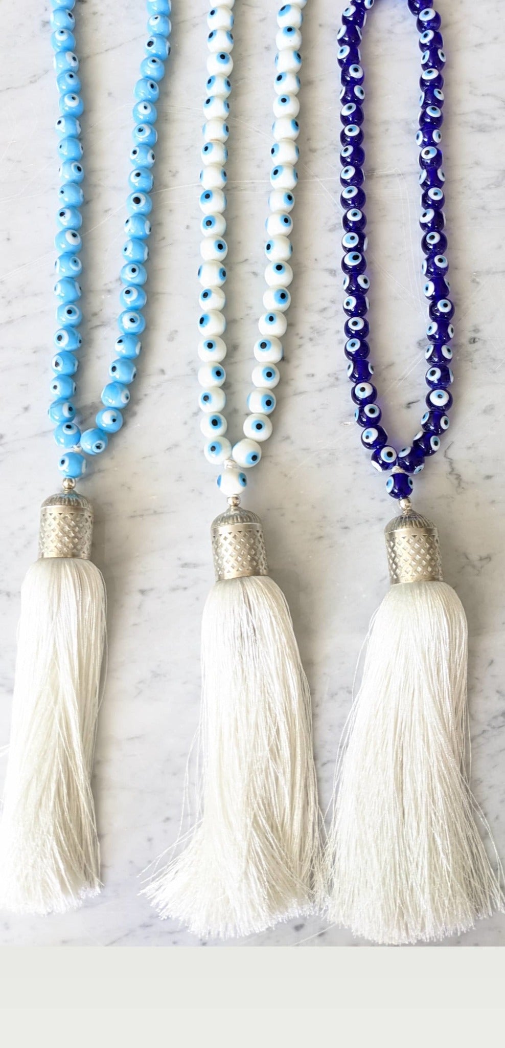 
Evil eye bead strand • Turquoise evil eye • Glass bead evil eye • Handmade evil eye • Misbaha beads • Modern prayer beads • Table decor evil eye • Boho home decor • Evil eye protection • Middle Eastern home decor • Housewarming gift • Meaningful gift • Stylish Luck • Made in Israel 
שרשרת עין הרע • חרוזי עין • קישוט שולחן • אובייקט עיצובי • חרוזי זכוכית בעבודת יד • מסבחה מודרנית • שמירה מעין הרע • עיצוב הבית • חפצי נוי • מתנה לחנוכת בית • מתנה משמעותית • סמלי מזל • Stylish Luck • מיוצר בישראל